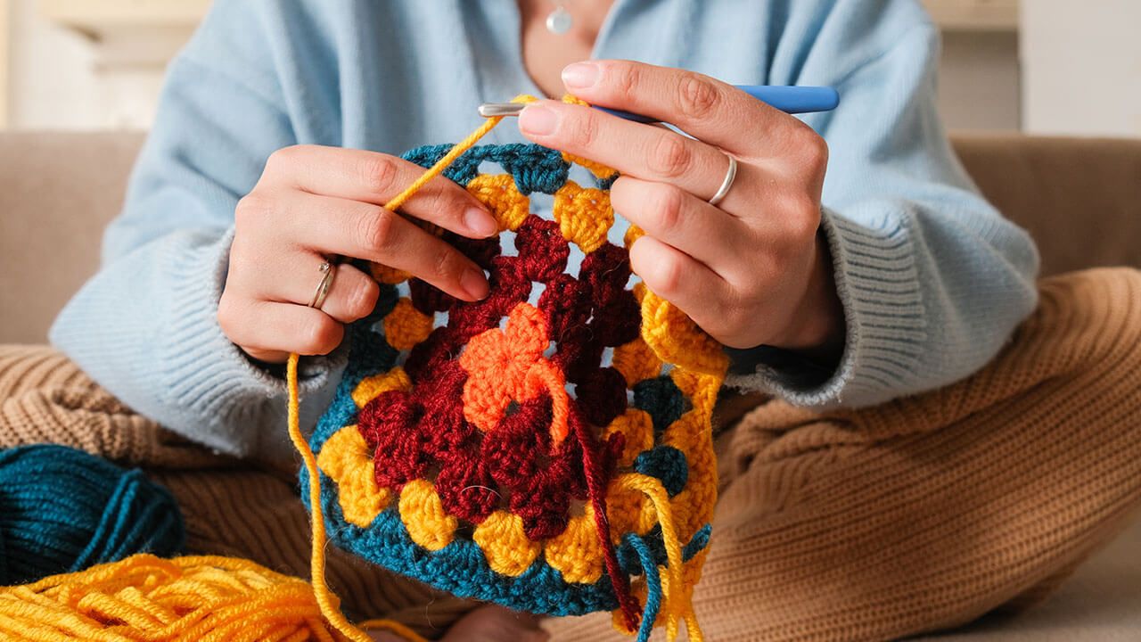 person creating crochet pattern