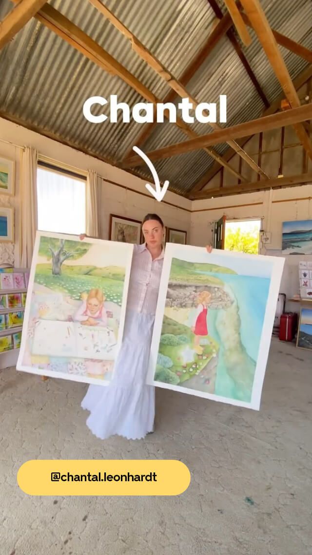 Woman holding two large paintings in a rustic art studio with wooden beams and corrugated metal ceiling. Text reads "Chantal."