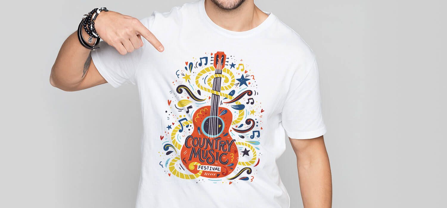 Person wearing a white T-shirt with a colorful guitar and musical notes design, featuring the text "Country Music Festival."