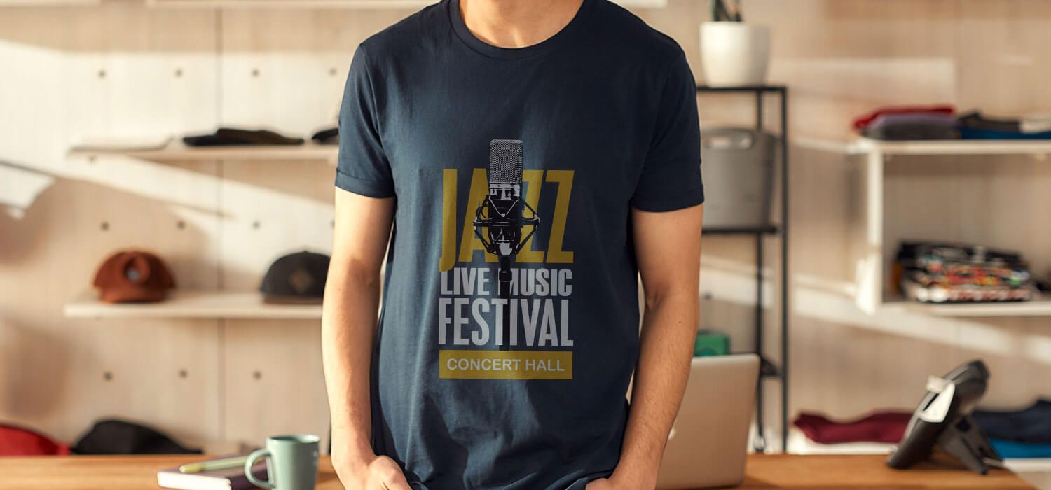 Person wearing a "Jazz Live Music Festival" t-shirt stands in a modern room with shelves and a hat in the background.