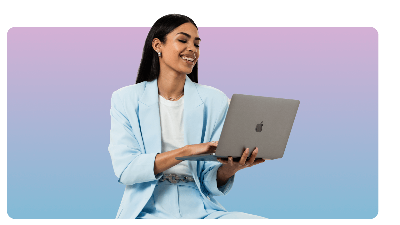 Woman in a light blue suit smiles while using a laptop, set against a gradient purple background.