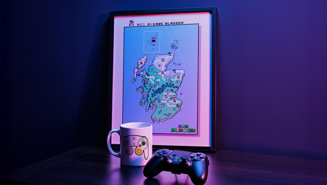 Framed pixel art map of Scotland on a table with a mug and a game controller under purple lighting.