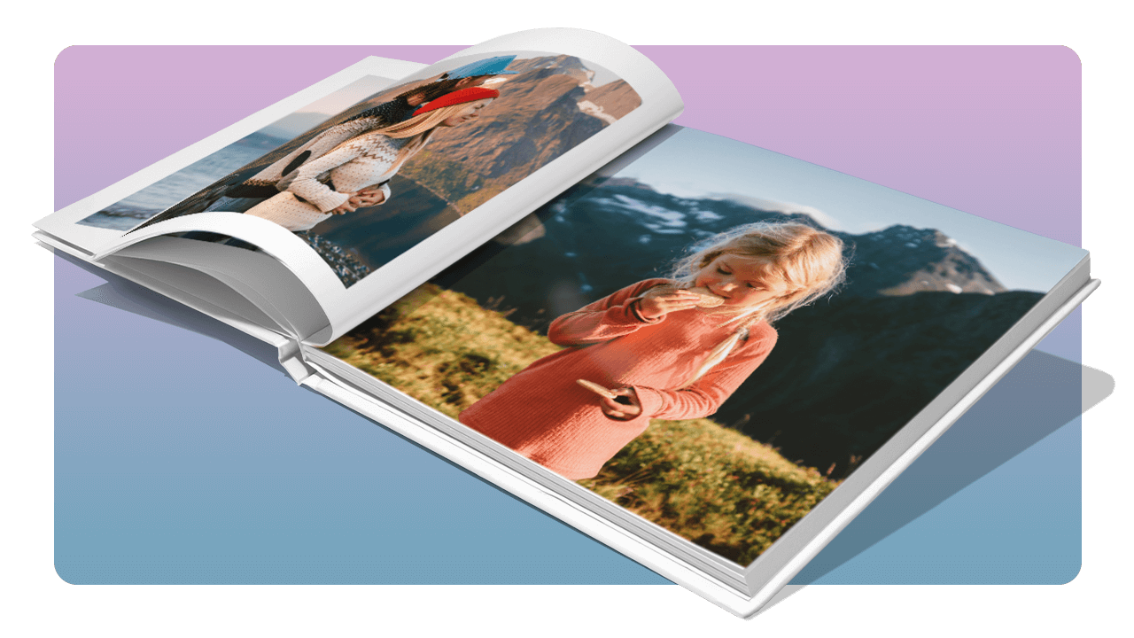 Open photo book showing a child in a pink dress standing in a scenic mountain landscape, with another image of a woman on the left page.